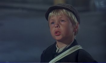 Movie still from “Bedknobs and Broomsticks” (1971), directed by Ward Kimball – A young boy wearing a hat and a uniform; Close Up shot, Low angle