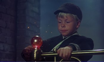 Movie still from “Bedknobs and Broomsticks” (1971), directed by Ward Kimball – A young boy holding onto a fire hydrant; Close Up shot, Low angle