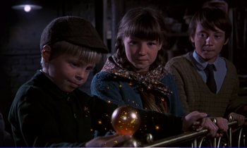Movie still from “Bedknobs and Broomsticks” (1971), directed by Ward Kimball – A group of children looking at a glowing object; Medium shot, Low angle