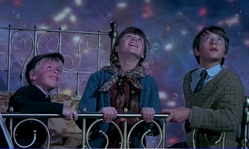 Movie still from “Bedknobs and Broomsticks” (1971), directed by Ward Kimball – Three children standing next to each other in front of a bed; Medium shot, High angle