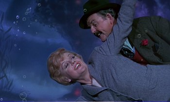 Movie still from “Bedknobs and Broomsticks” (1971), directed by Ward Kimball – An older man and a younger woman are posing for a picture; Medium shot, High angle