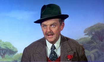 Movie still from “Bedknobs and Broomsticks” (1971), directed by Ward Kimball – A man in a green hat and a brown jacket; Close Up shot, Low angle