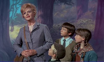 Movie still from “Bedknobs and Broomsticks” (1971), directed by Ward Kimball – A woman standing next to two young children; Medium shot, Low angle