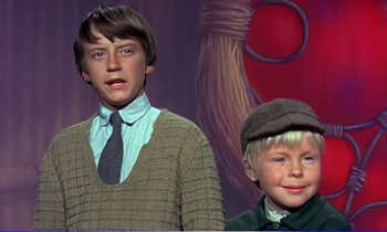 Movie still from “Bedknobs and Broomsticks” (1971), directed by Ward Kimball – Two young boys standing next to each other in front of a painting; Medium shot, Low angle