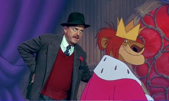 Movie still from “Bedknobs and Broomsticks” (1971), directed by Ward Kimball – A man in a suit and hat standing in front of a cartoon bear; Medium shot, Low angle