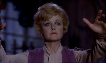 Movie still from “Bedknobs and Broomsticks” (1971), directed by Ward Kimball – An older woman is looking at something in the air; Close Up shot, Low angle