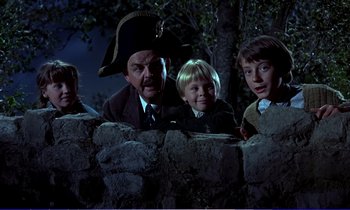 Movie still from “Bedknobs and Broomsticks” (1971), directed by Ward Kimball – A group of children and a man in a pirate hat; Medium shot, Low angle