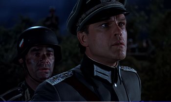 Movie still from “Bedknobs and Broomsticks” (1971), directed by Ward Kimball – A man in a military uniform and a man in a uniform; Close Up shot, Low angle