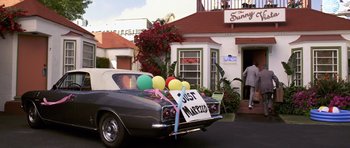Movie still from “Bedtime Stories” (2008), directed by Adam Shankman – A car that is parked on the side of the street; Wide shot, High angle