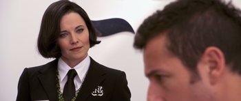 Movie still from “Bedtime Stories” (2008), directed by Adam Shankman – A woman wearing a suit and tie standing in front of a man; Close Up shot, Over the shoulder angle