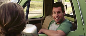 Movie still from “Bedtime Stories” (2008), directed by Adam Shankman – A man sitting in the driver's seat of a car; Medium shot, Over the shoulder angle