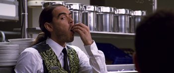 Movie still from “Bedtime Stories” (2008), directed by Adam Shankman – A man wearing a vest and tie eating something; Close Up shot, High angle