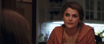 Movie still from “Bedtime Stories” (2008), directed by Adam Shankman – A person sitting at a table; Close Up shot, Over the shoulder angle