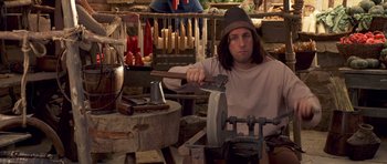 Movie still from “Bedtime Stories” (2008), directed by Adam Shankman – A man is working in a shop with a hammer; Medium shot, High angle