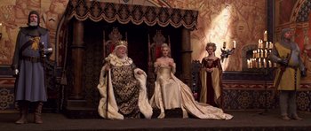 Movie still from “Bedtime Stories” (2008), directed by Adam Shankman – Two women and a man dressed as a king and a queen; Wide shot, High angle