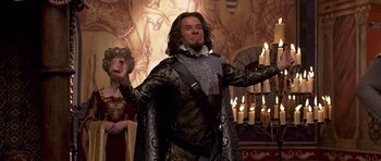 Movie still from “Bedtime Stories” (2008), directed by Adam Shankman – A man dressed in medieval garb holding a sword; Medium shot, Low angle