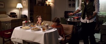 Movie still from “Bedtime Stories” (2008), directed by Adam Shankman – Two children sitting at a dinner table eating food; Medium shot, High angle