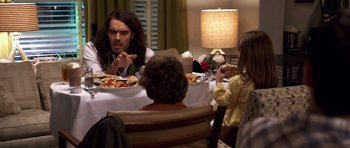 Movie still from “Bedtime Stories” (2008), directed by Adam Shankman – A group of people sitting around a table eating food; Medium shot, Over the shoulder angle