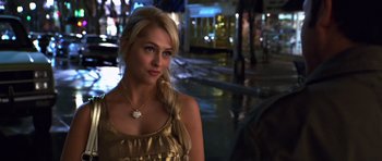 Movie still from “Bedtime Stories” (2008), directed by Adam Shankman – A beautiful blonde woman in a gold dress; Close Up shot, Over the shoulder angle