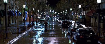 Movie still from “Bedtime Stories” (2008), directed by Adam Shankman – A person riding a bike down a street at night; Extreme Wide shot, High angle