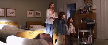 Movie still from “Bedtime Stories” (2008), directed by Adam Shankman – A group of people standing in a room; Wide shot, Over the shoulder angle