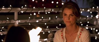 Movie still from “Bedtime Stories” (2008), directed by Adam Shankman – A beautiful woman standing in front of lights; Close Up shot, Over the shoulder angle