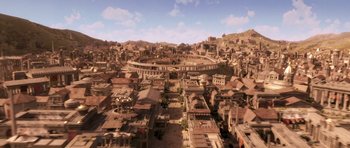 Movie still from “Bedtime Stories” (2008), directed by Adam Shankman – An aerial view of an old city with a large circular arena; Extreme Wide shot, High angle