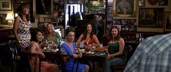Movie still from “Bedtime Stories” (2008), directed by Adam Shankman – A group of women sitting at a table with plates of food; Wide shot, High angle