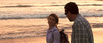 Movie still from “Bedtime Stories” (2008), directed by Adam Shankman – A man and a woman standing next to each other on the beach; Medium shot, Over the shoulder angle