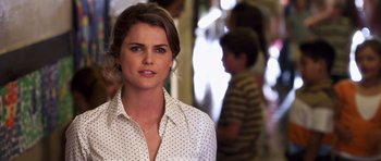 Movie still from “Bedtime Stories” (2008), directed by Adam Shankman – A woman in a white polka dot shirt; Close Up shot, Over the shoulder angle