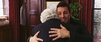 Movie still from “Bedtime Stories” (2008), directed by Adam Shankman – A man hugging another man in front of a wall; Close Up shot, Over the shoulder angle