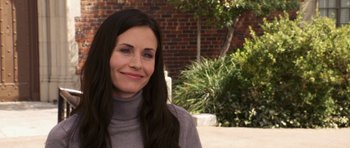 Movie still from “Bedtime Stories” (2008), directed by Adam Shankman – A woman with long black hair smiles for the camera; Close Up shot, Over the shoulder angle