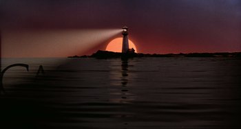 Movie still from “Before Sunrise” (1995), directed by Richard Linklater – The sun is setting behind a lighthouse on the water; Extreme Wide shot, Low angle