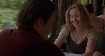 Movie still from “Before Sunrise” (1995), directed by Richard Linklater – A man and a woman sitting in front of a table; Medium shot, Over the shoulder angle
