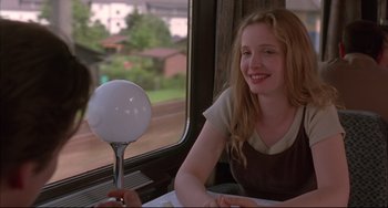 Movie still from “Before Sunrise” (1995), directed by Richard Linklater – A woman sitting at a table in front of a mirror; Medium shot, Over the shoulder angle
