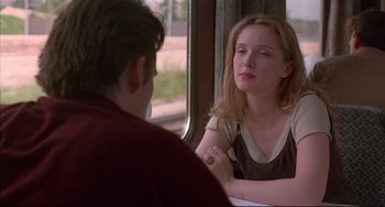 Movie still from “Before Sunrise” (1995), directed by Richard Linklater – A young man and a young woman sitting at a train window; Close Up shot, Over the shoulder angle