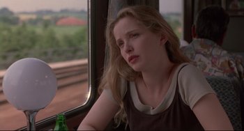 Movie still from “Before Sunrise” (1995), directed by Richard Linklater – A woman sitting on a train looking out the window; Close Up shot, Over the shoulder angle