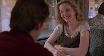 Movie still from “Before Sunrise” (1995), directed by Richard Linklater – A woman sitting at a table with a man; Close Up shot, Over the shoulder angle