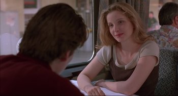 Movie still from “Before Sunrise” (1995), directed by Richard Linklater – A woman sitting next to a man in front of a train window; Medium shot, Over the shoulder angle