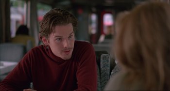 Movie still from “Before Sunrise” (1995), directed by Richard Linklater – A man sitting at a table in front of a woman; Close Up shot, Over the shoulder angle