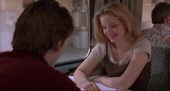 Movie still from “Before Sunrise” (1995), directed by Richard Linklater – A woman sitting next to a man on a train; Medium shot, Over the shoulder angle