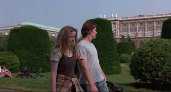 Movie still from “Before Sunrise” (1995), directed by Richard Linklater – A man and a woman walking through a park; Medium shot, Low angle