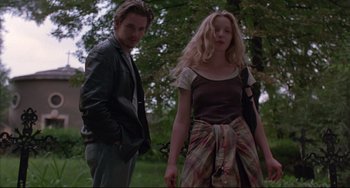Movie still from “Before Sunrise” (1995), directed by Richard Linklater – A man and a woman standing next to each other in a forest; Medium shot, Low angle