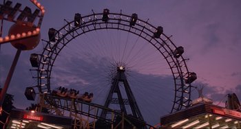 Movie still from “Before Sunrise” (1995), directed by Richard Linklater – A ferris wheel with people riding on it at night; Extreme Wide shot, Low angle