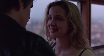 Movie still from “Before Sunrise” (1995), directed by Richard Linklater – A young woman smiles as she talks to a young man in a car; Close Up shot, Over the shoulder angle
