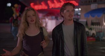 Movie still from “Before Sunrise” (1995), directed by Richard Linklater – A man and a woman walking down a street; Medium shot, Low angle