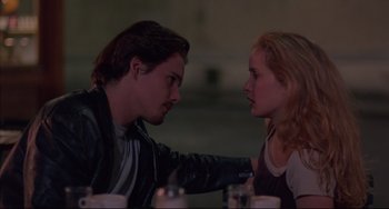 Movie still from “Before Sunrise” (1995), directed by Richard Linklater – A man and a woman sitting at a dinner table; Close Up shot, Low angle