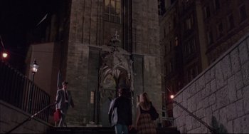 Movie still from “Before Sunrise” (1995), directed by Richard Linklater – A group of people walking up stairs in front of a building; Wide shot, High angle
