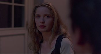 Movie still from “Before Sunrise” (1995), directed by Richard Linklater – A beautiful young woman with long , blonde hair; Close Up shot, Over the shoulder angle