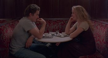 Movie still from “Before Sunrise” (1995), directed by Richard Linklater – A man and a woman sitting at a table with a cup of coffee; Medium shot, Over the shoulder angle